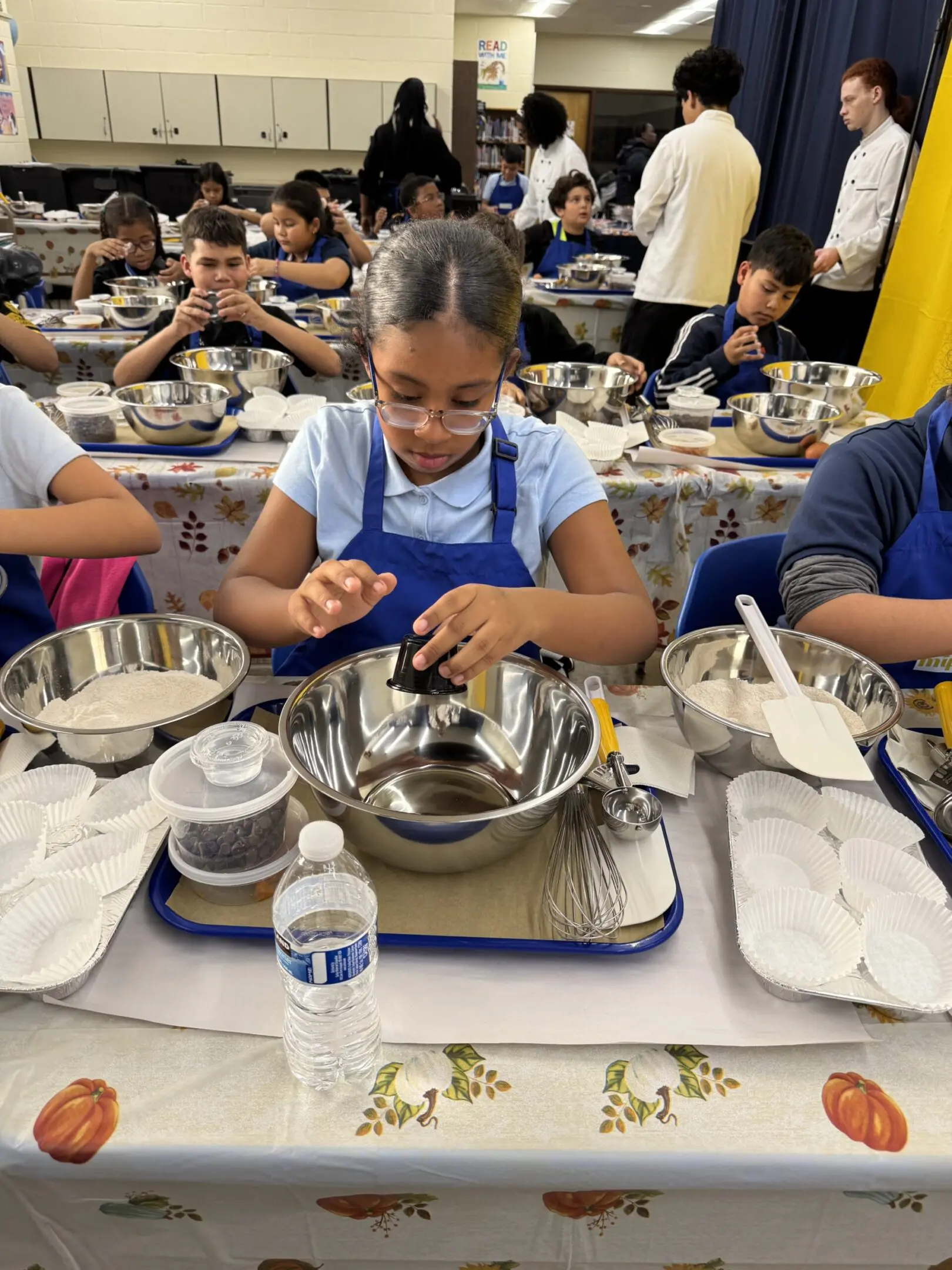 Kids participate in school cooking activity.