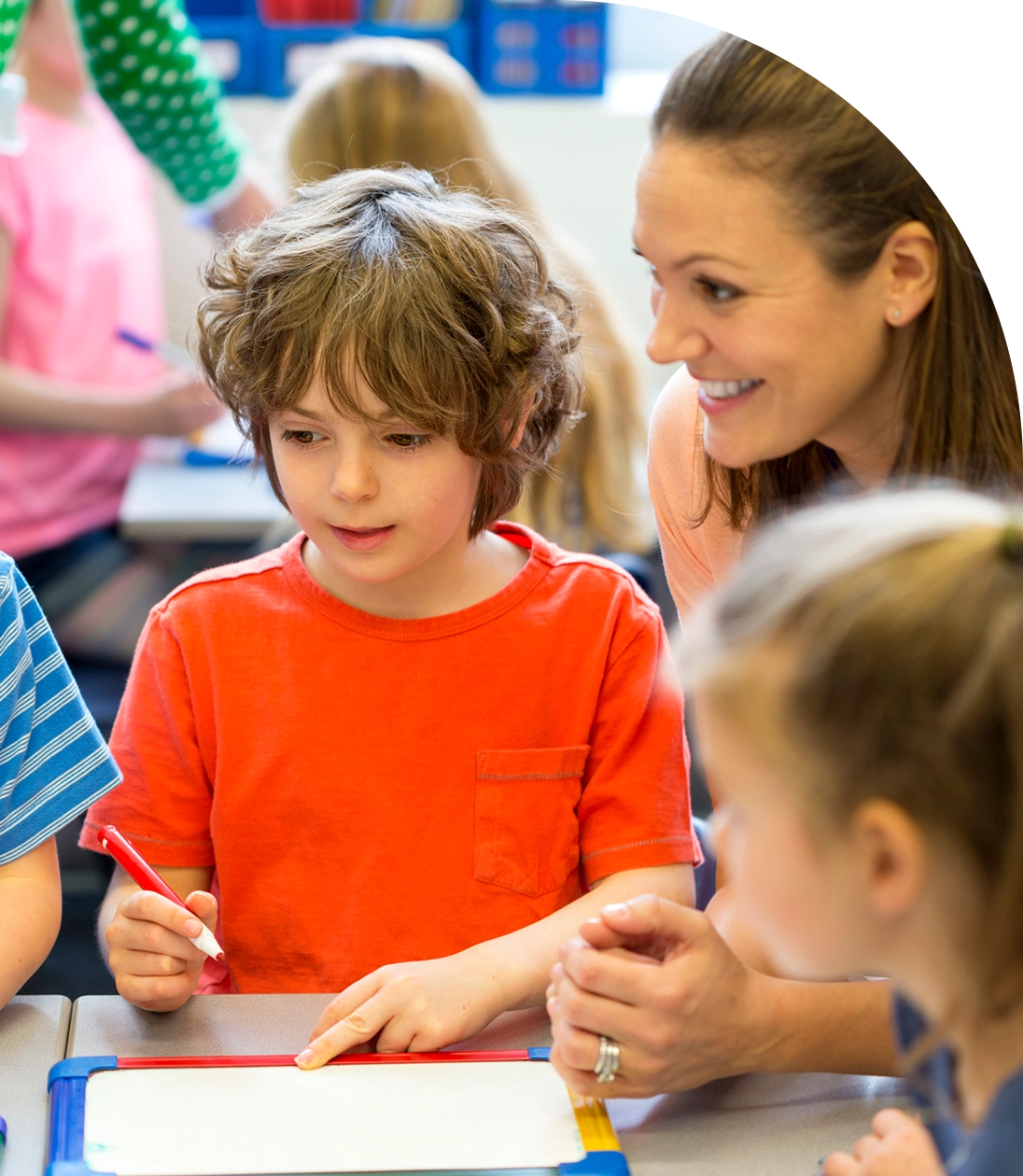 Teacher assisting child with writing task